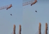 China-paragliding-man-stuck-on-tower-crane