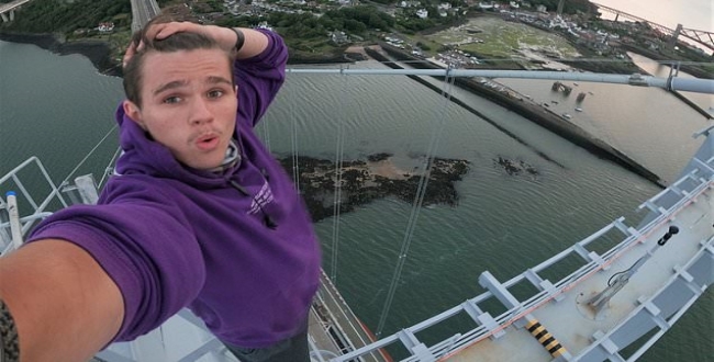 Terrifying moment teenage daredevil risks his life to climb Forth Road Bridge in Scotland