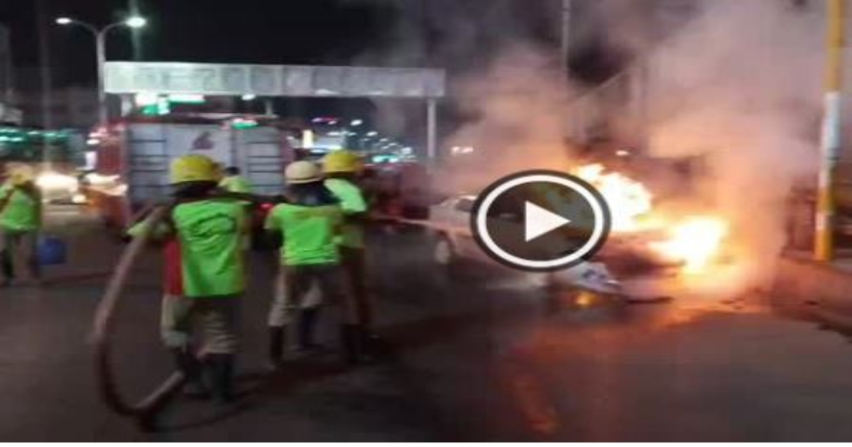 A car caught fire at a bus stand when it stopped at a signal