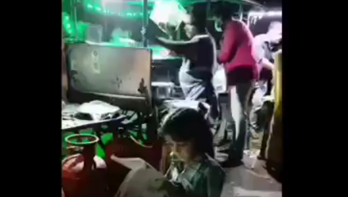 Small boy studying in father roadside shop