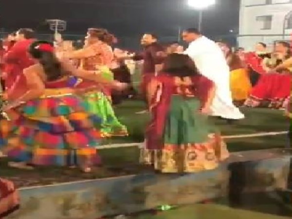 father dancing in hindu festival 