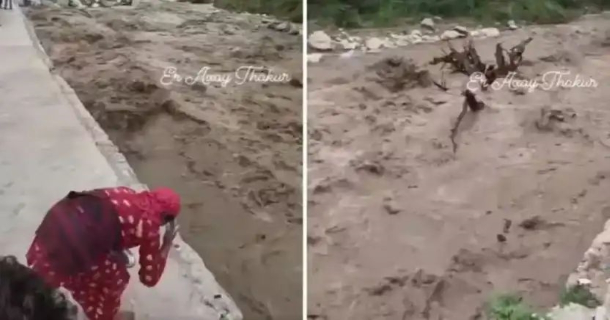 nepal-flood-woman-prays-to-raging-river
