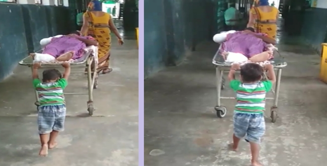 6 year old old boy pushing grandfather's stretcher