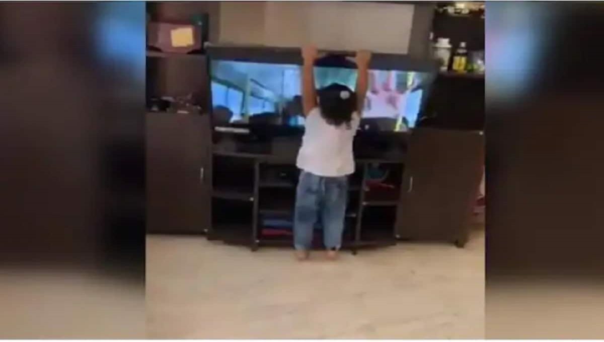 Toddler tries to dance like tv song and bring down the TV