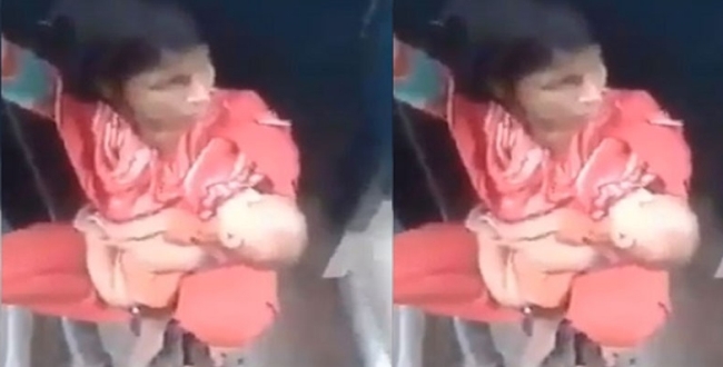 Women with baby in between running train compartments video