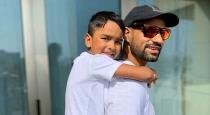 indian-cricket-player-feed-food-for-animal-with-son