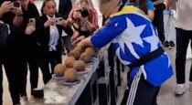 Breaking-coconuts-blindfolded-with-one-hand