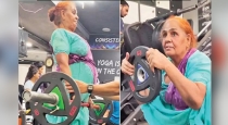 68 years old lady lifting weight at gym 